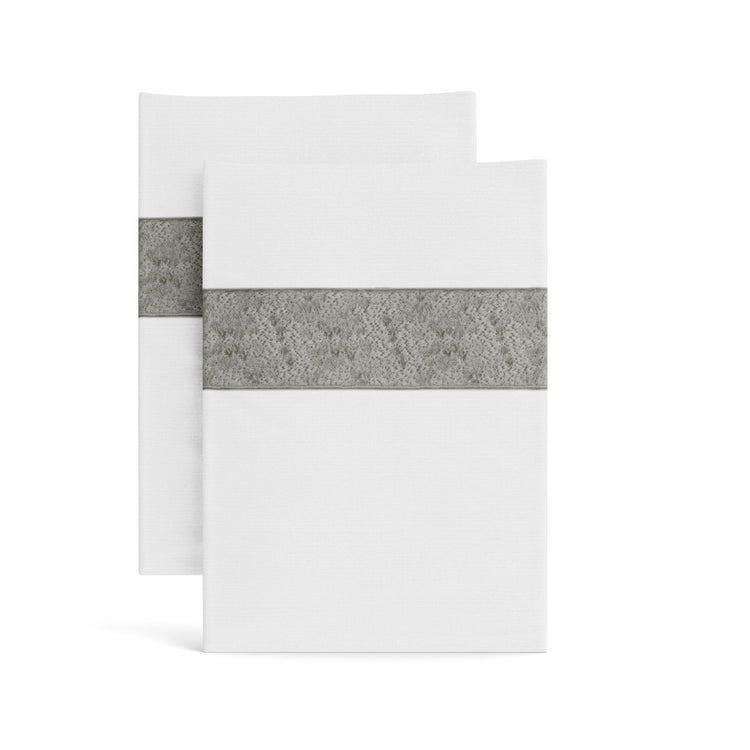 Stacked white Minaudiere pillowcases from the Judith Leiber Couture x Ann Gish collection, detailed with a metallic grey sequined border band that echoes the jeweled Minaudiere motif. - PCMIK‑WHI‑MET PCMIS‑WHI‑MET