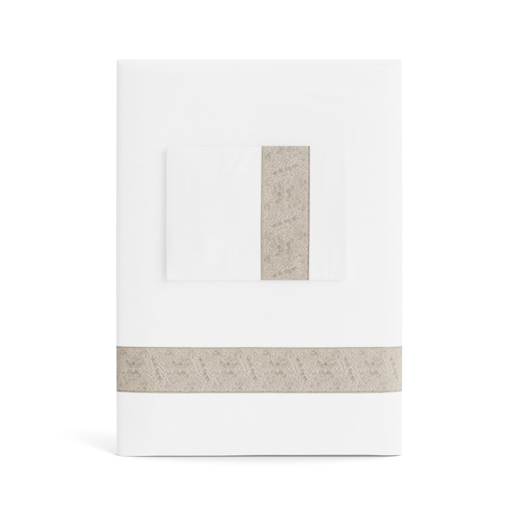 A folded white Minaudiere Sheet Set by Judith Leiber Couture x Ann Gish, shown with its matching pillowcase on top, featuring a taupe sequenced border band that mirrors the jeweled sparkle of the Minaudiere design. - SSMIK-WHI-TAU SSMIQ-WHI-TAU