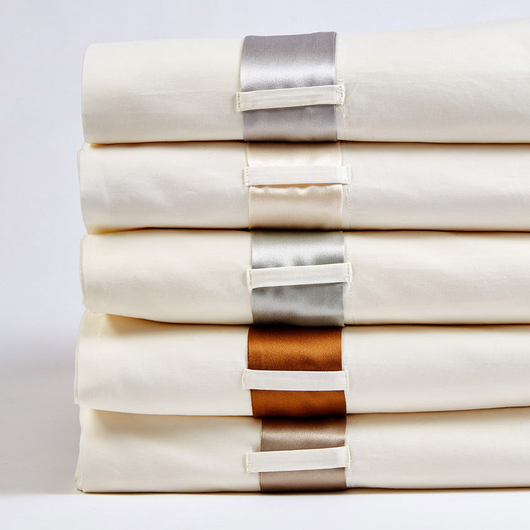 Stack of Ivory Cotton Sheet with Silk Band